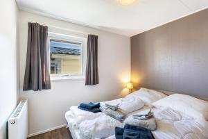 a small bedroom with a bed with a window at Chalet 91 in Brilon