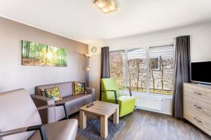 a living room with a couch and a tv at Chalet 91 in Brilon