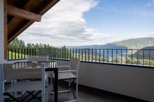 a balcony with a table and chairs and a view at Ladinser Hof Western Suite in Castelrotto