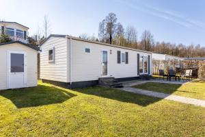 a white tiny house in a yard at Chalet 91 in Brilon