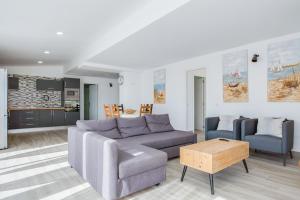 a living room with a couch and two chairs at Ático deluxe Corralejo centro in Corralejo