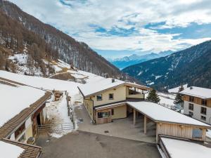 a view of a snow covered mountain with buildings at Hof Am Egg in Malles Venosta