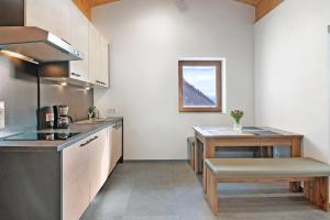 a kitchen with a counter and a table in it at Hof Am Egg in Malles Venosta