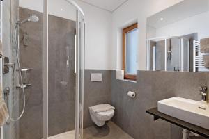 a bathroom with a shower and a toilet and a sink at Hof Am Egg in Malles Venosta +26 photos