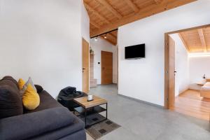 a living room with a couch and a table at Hof Am Egg in Malles Venosta