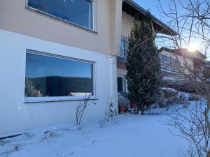 a house with a window in the snow at Lichtblick unter der Buche in Titisee-Neustadt +9 photos
