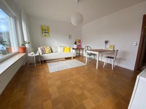 a living room with a couch and a table at Lichtblick unter der Buche in Titisee-Neustadt
