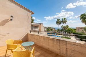a patio with chairs and a table on a balcony at Pedrassa Gran Superior in Cala Santanyi