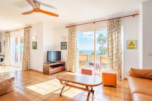 a living room with a couch and a table at Pedrassa Gran Superior in Cala Santanyi