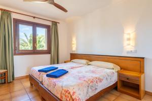 a bedroom with a bed with blue towels on it at Pedrassa Gran Superior in Cala Santanyi +17 photos