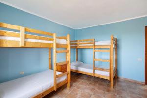 two bunk beds in a room with blue walls at Finca Vidalenta El Salobre in Salobre +18 photos