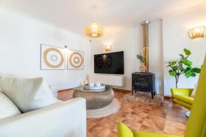 a living room with a couch and a fire place at Voramar Alcudia in Alcudia
