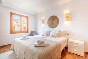 a bedroom with two towels on a bed at Voramar Alcudia in Alcudia