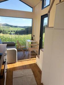 a living room with a couch and a large window at Zuhause im Freien in Stockach