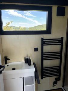 a bathroom with a white sink and a window at Zuhause im Freien in Stockach