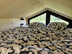 a bed in a room with a large window at Zuhause im Freien in Stockach