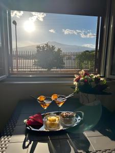 a tray with two martini glasses on a table in front of a window at Da Pina E Lu in Giardini Naxos +16 photos