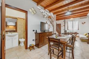 a kitchen and dining room with a table and chairs at Casa rustica in Gonnesa