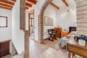 a living room with a bed and a desk in a room at Casa rustica in Gonnesa