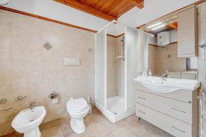 a bathroom with a toilet and a sink and a shower at Casa rustica in Gonnesa +15 photos