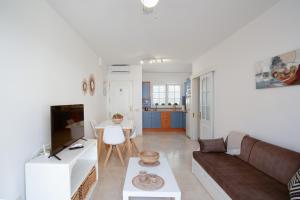 a living room with a couch and a table at Mangueros Suite 36 Puerto de Mogán in Puerto de Mogán