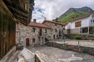 a group of buildings with a mountain in the background at Lorences A in Caunedo