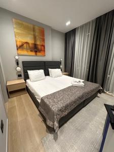a bedroom with a bed and a painting on the wall at Sea Breeze, Polo Residence, Baku, MR in Nardaran +16 photos