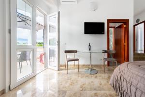 a bedroom with a bed and a table and chairs at I 4 Venti in Melendugno