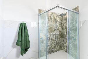 a shower in a bathroom with a green towel at I 4 Venti in Melendugno +93 photos