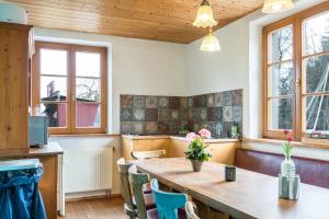 a kitchen with a large wooden table and chairs at Ferienwohnung Tipihof in Sauldorf