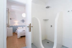 a bedroom with white walls and a bed in a room at Livadia Seaside Studios 6 in Parikia