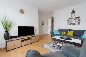 a living room with a couch and a flat screen tv at Ferienwohnung oberhalb vom Hafen 2 in Sassnitz