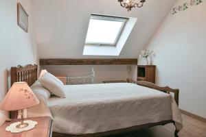 a bedroom with a bed with a window and a table at Gîte Yveco in Châteauneuf