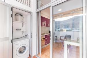 a laundry room with a washing machine and a table at Vv Velero in Puerto de Mogán