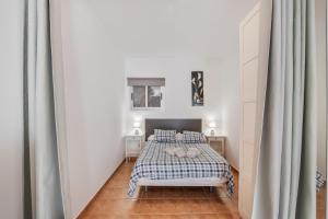 a bedroom with a bed in a white room at Vv Velero in Puerto de Mogán