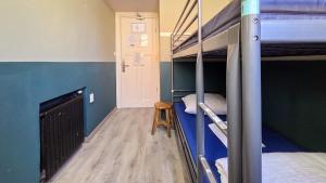 a room with two bunk beds and a wooden floor at Hostel Cosmos Amsterdam in Amsterdam
