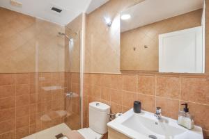 a bathroom with a toilet and a sink and a shower at Vv Velero in Puerto de Mogán +25 photos