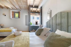 a large room with a bed and a window at Maison d'hôtes de Gailhaguet in Verfeil +61 photos
