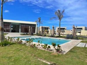 a swimming pool in front of a building at Atabey II – Epic Residence, Bávaro in Punta Cana