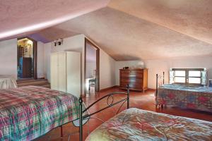 a bedroom with two beds and a dresser at Casa della Barcareccia - per gruppi in Calice al Cornoviglio