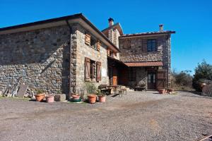 a stone building with potted plants in front of it at Casa della Barcareccia - per gruppi in Calice al Cornoviglio