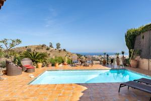 a swimming pool in the middle of a patio at Cosy house jacuzzi wifi pool view in Mijas