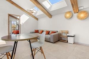 a living room with a table and a couch at La Master Grange De Queyran in La Palud-sur-Verdon +12 photos