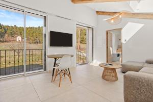 a living room with a couch and a table at La Master Grange De Queyran in La Palud-sur-Verdon