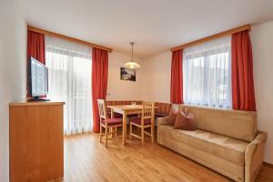 a living room with a couch and a table at Haus Weitgasser in Flachau
