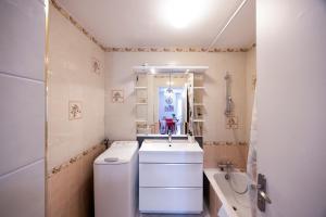 a white bathroom with a sink and a toilet at Studio Montcalm in Aix-les-Bains +15 photos
