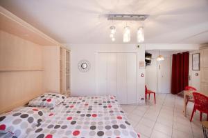 a bedroom with a bed with polka dots on it at Studio Montcalm in Aix-les-Bains