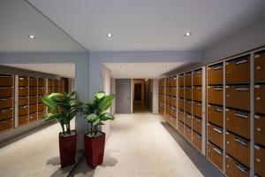 a locker room with brown lockers and a plant at Studio Montcalm in Aix-les-Bains