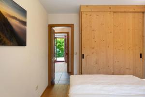 a bedroom with a bed and a wooden door at Ammerheimat in Oberammergau