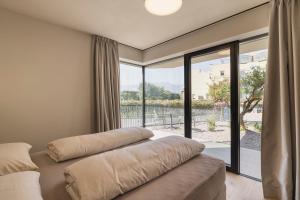 a bedroom with two beds and a large window at Trianglhof surrounded by vineyards in Bolzano +83 photos